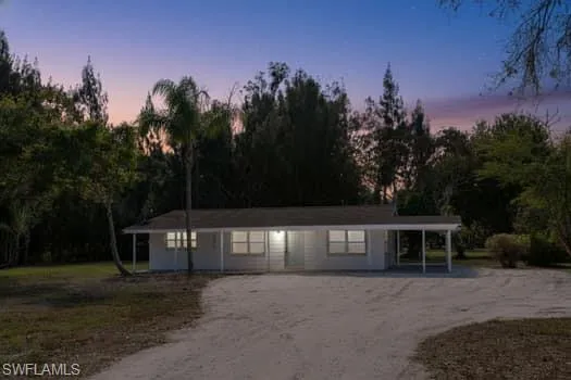 Ranch-style house with driveway and covered porch