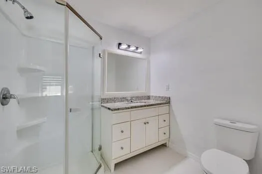Bathroom featuring a stall shower and vanity