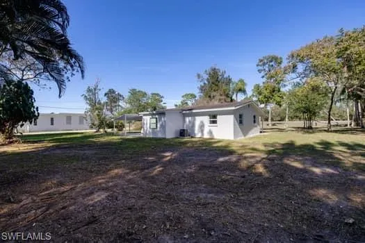 Back of property featuring a yard