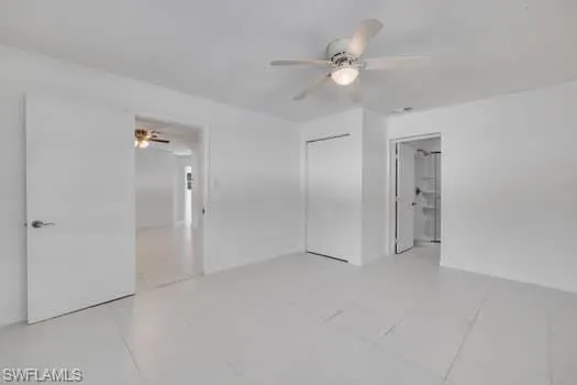 Unfurnished bedroom with a closet, ceiling fan, and light tile patterned floors