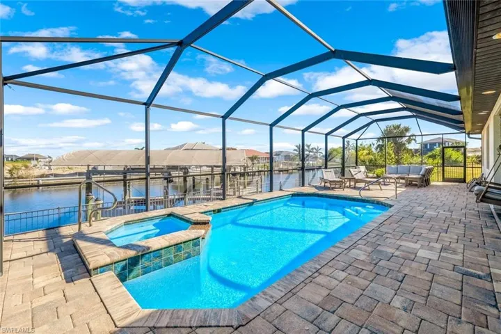 Heated Pool with a spa and feature of canal