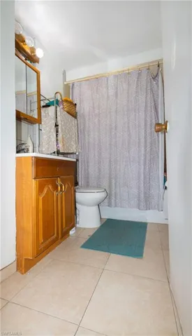 Bathroom featuring tile flooring, vanity, and toilet