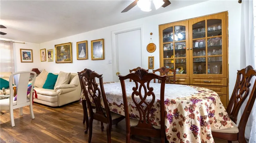 Dining area featuring ceiling fan and dark hardwood / wood-style flooring