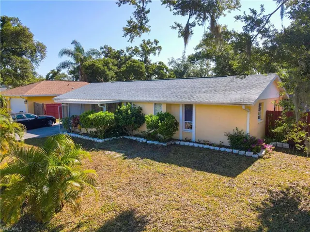 Single story home featuring a front lawn