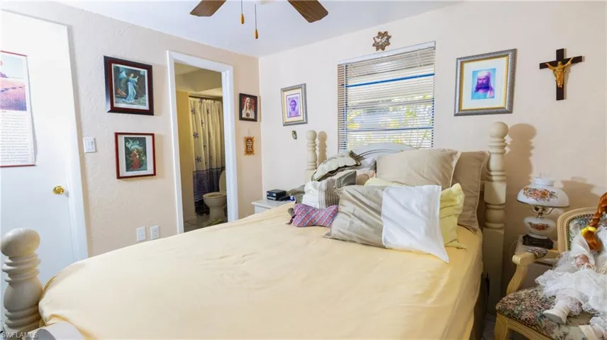 Bedroom with ceiling fan and ensuite bath