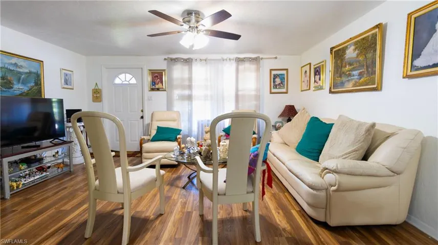 Living room featuring ceiling fan and hardwood / wood-style floors