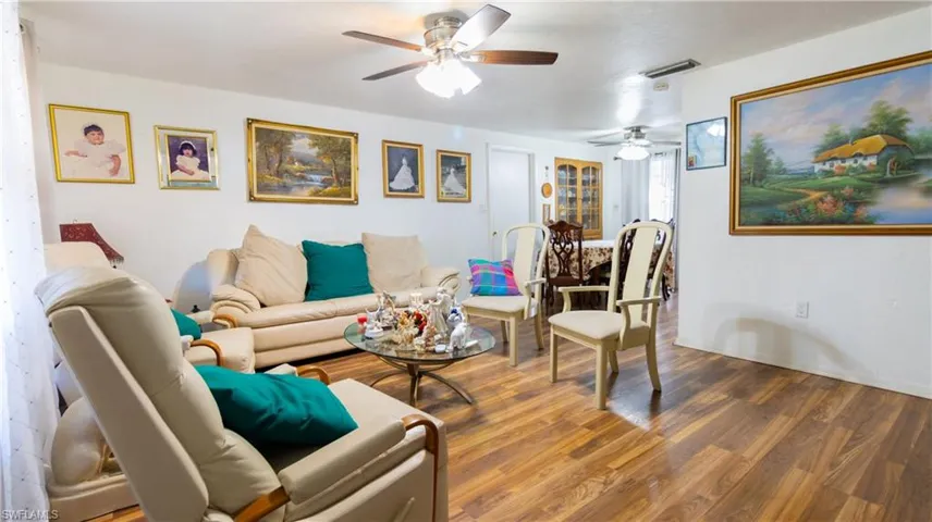 Living room featuring ceiling fan and wood-type flooring