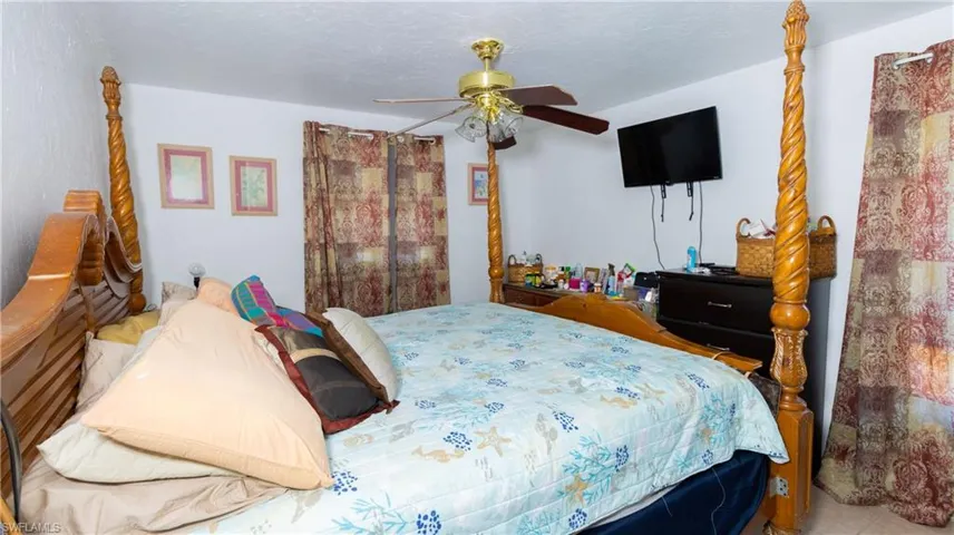 Bedroom featuring ceiling fan and a textured ceiling