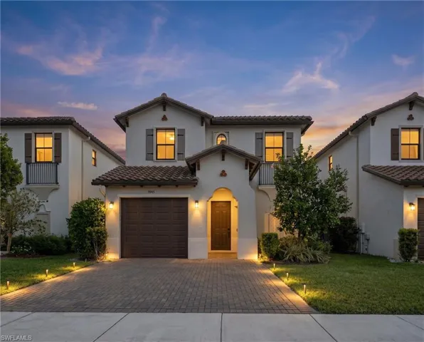 Mediterranean-inspired architecture featuring a terracotta tile roof and stucco exterior