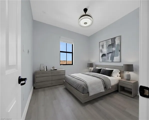 Virtually Staged*Bedroom with wood-finish flooring, a window offering natural light, and a ceiling fan with integrated lighting