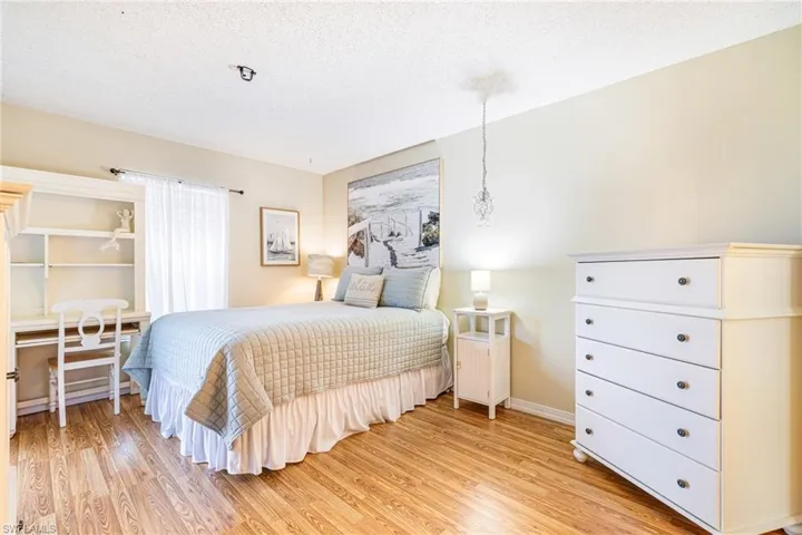 Bedroom featuring a textured ceiling and light wood-type flooring