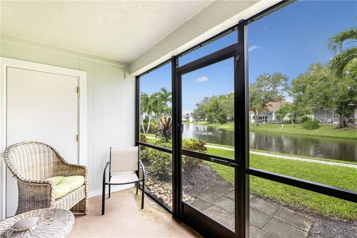 Sunroom / solarium featuring a water view