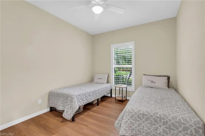 Bedroom featuring ceiling fan and hardwood / wood-style flooring