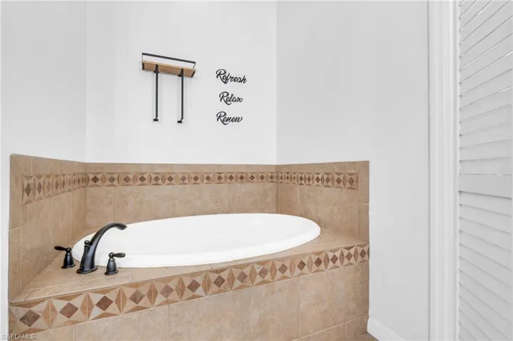 Bathroom featuring tiled bath