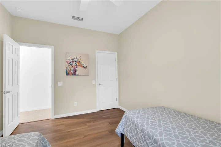 Bedroom featuring ceiling fan and dark hardwood / wood-style floors