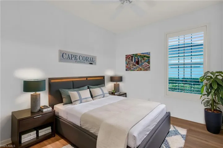 Bedroom featuring ceiling fan and hardwood / wood-style floors