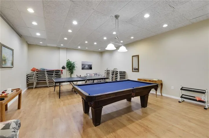 Recreation room featuring billiards, a paneled ceiling, and light wood-type flooring