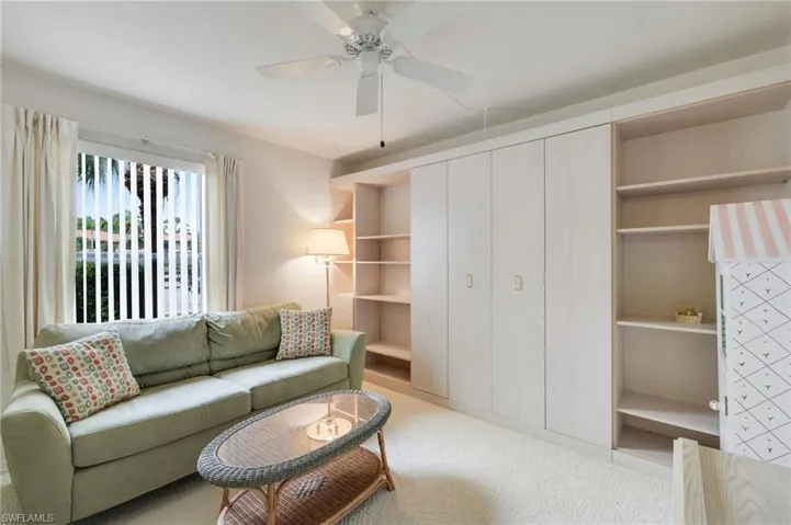 Living room featuring carpet and ceiling fan