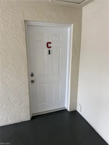 View of exterior entry with stucco siding