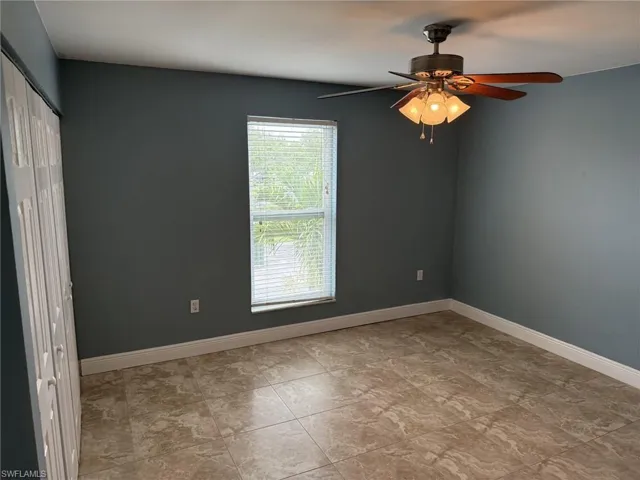 Spare room with baseboards and ceiling fan