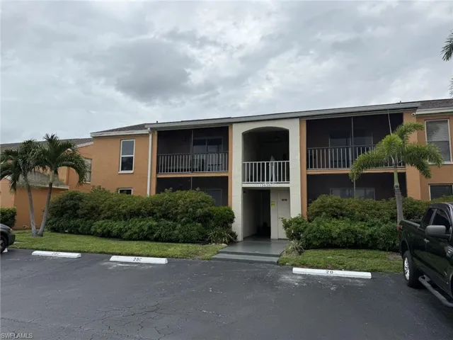 View of building exterior with uncovered parking