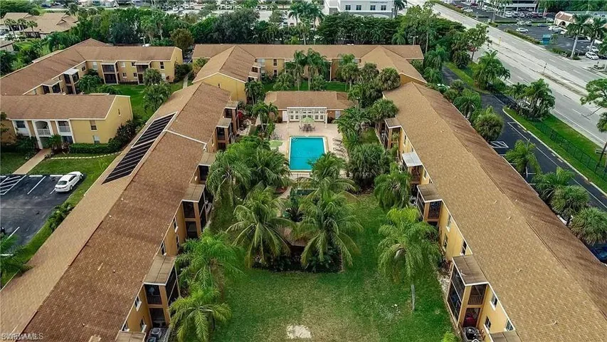 Aerial perspective of suburban area featuring a pool