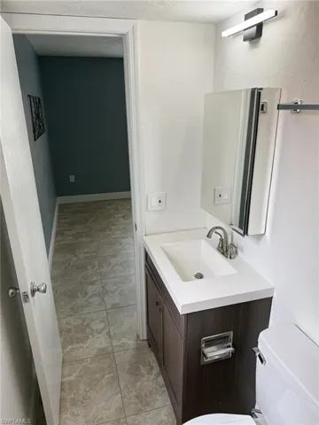 Half bath with vanity and toilet