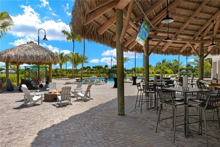 View of patio featuring a gazebo, a community pool, and a fire pit