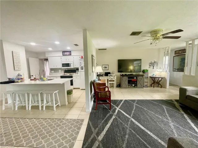 Tiled living room featuring large window.