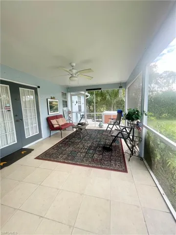 Sunroom / solarium featuring ceiling fan
