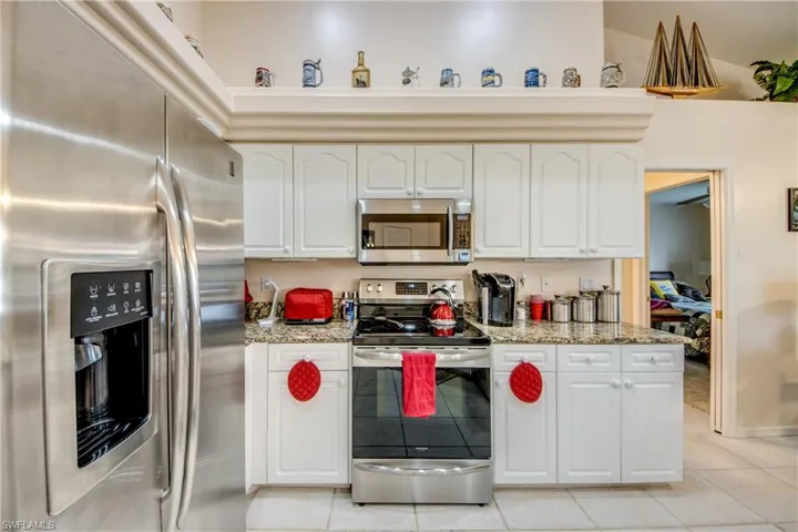 Another view of the spacious kitchen with display shelves.