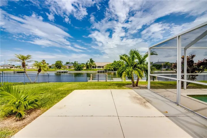 View of patio on side yard with a water view. You can enjoy grilling out here.