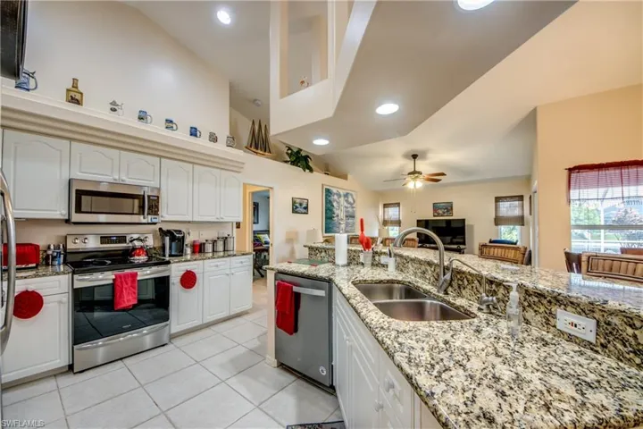 Kitchen looking into family room back center and breaksfast nook on the right