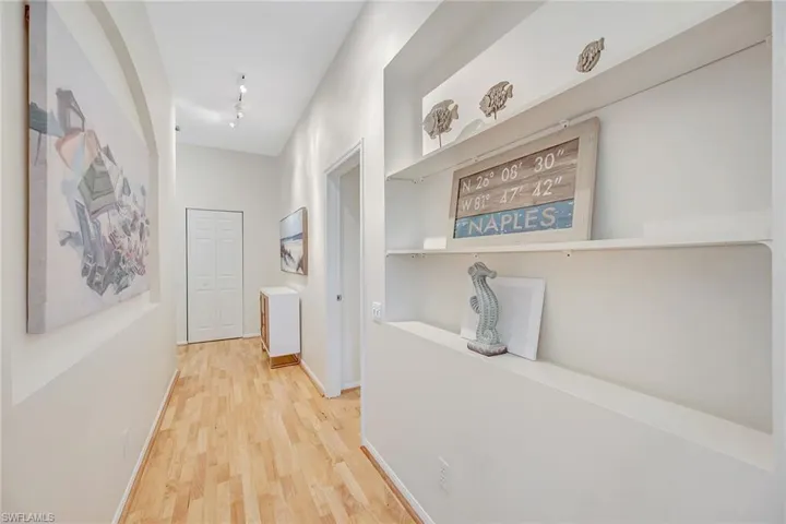 Hallway connecting stairs to living space; guest suite on right