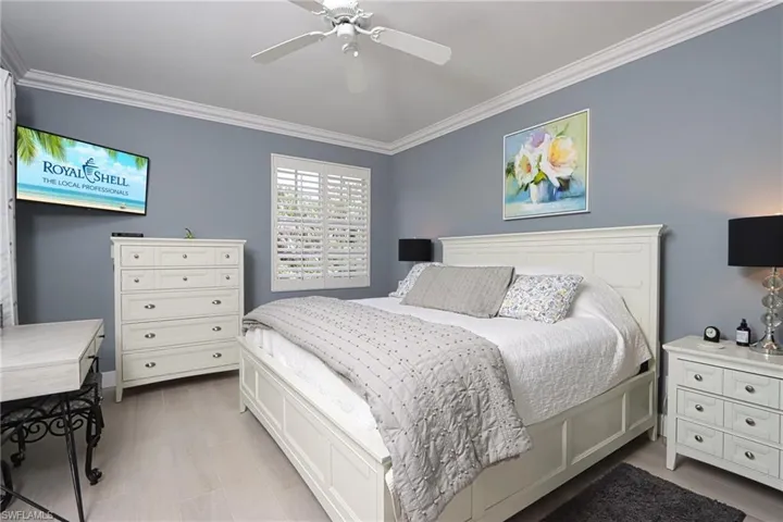 Bedroom with crown molding and a ceiling fan
