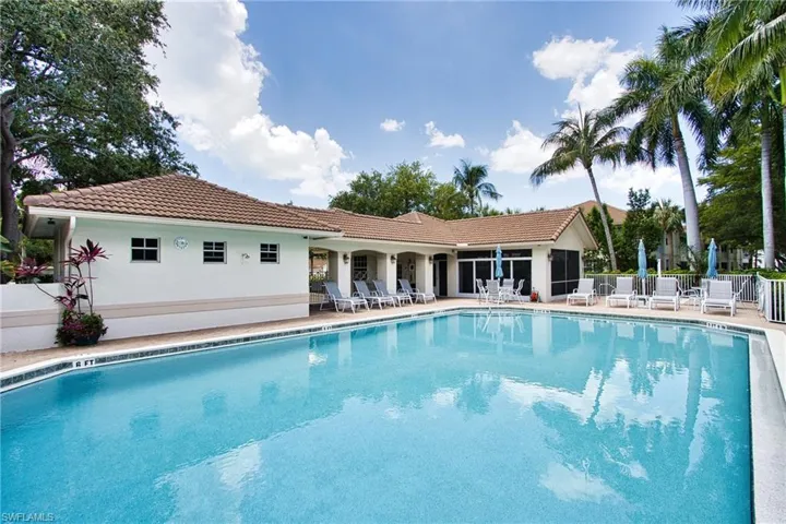 Community pool with fence and a patio