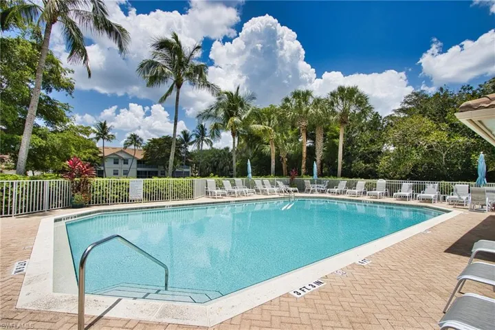 Community pool featuring fence and a patio area
