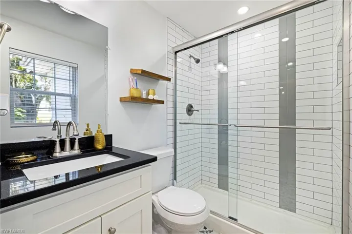 Full bath featuring vanity and a stall shower