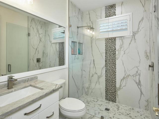 Remodeled "Jack and Jill" guest bath between two guest bedrooms. Frameless shower door, soft rain showerhead and 'waterfall' tile appearance on window wall. New cabinetry, plumbing and quartz countertop.
