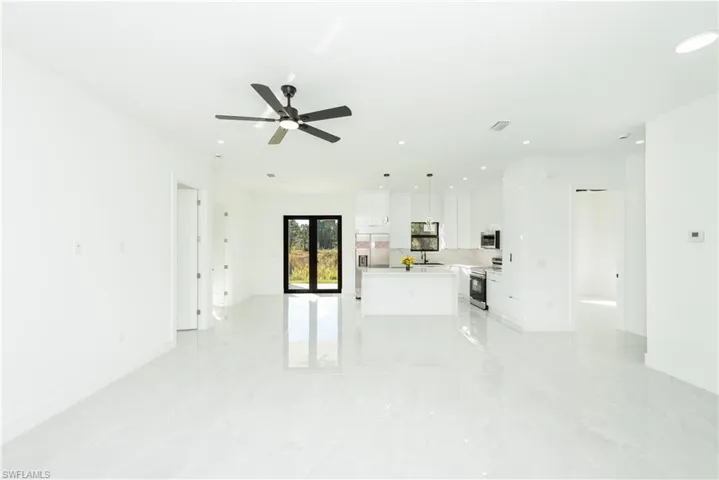 Unfurnished living room with recessed lighting and ceiling fan