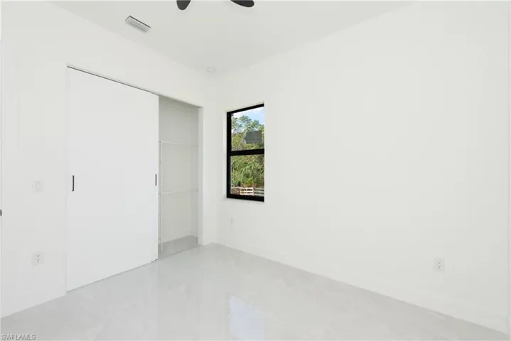 Unfurnished bedroom featuring a closet and ceiling fan