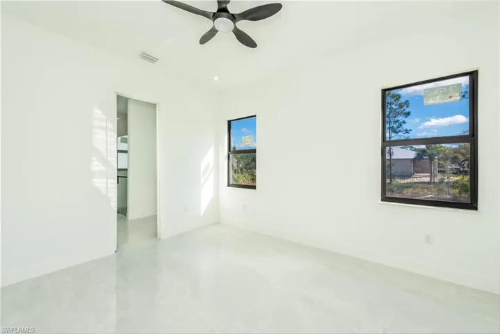 Unfurnished room featuring baseboards and a ceiling fan