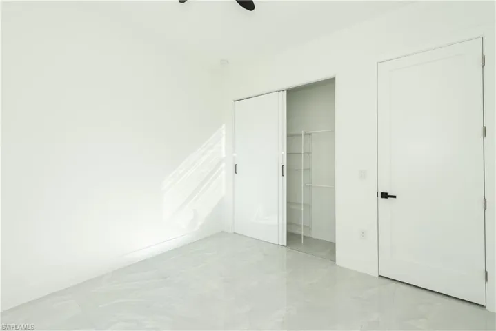 Unfurnished bedroom featuring a closet and a ceiling fan