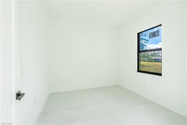 Empty room featuring baseboards