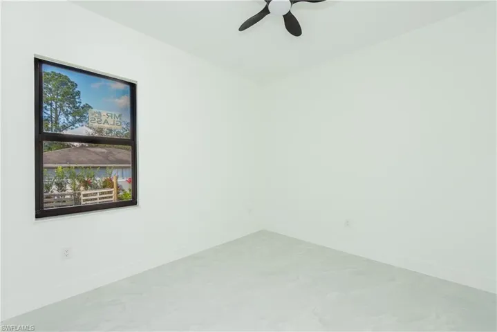 Unfurnished room with baseboards and ceiling fan