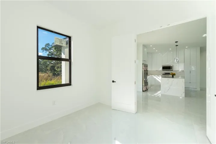 Spare room featuring baseboards