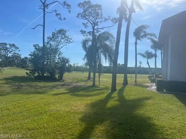 View of home's community with a lawn