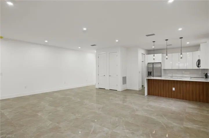 Unfurnished living room with sink
