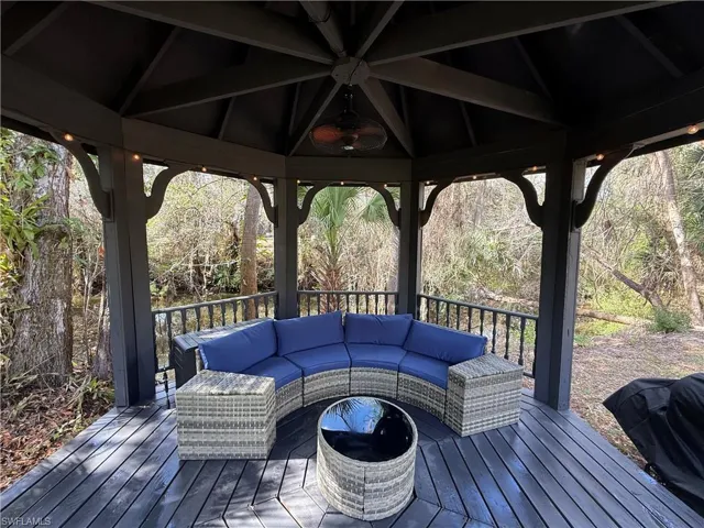 Deck with a gazebo and an outdoor hangout area