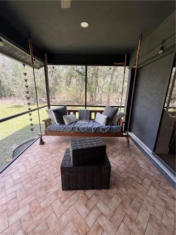 Sunroom featuring a hot tub
